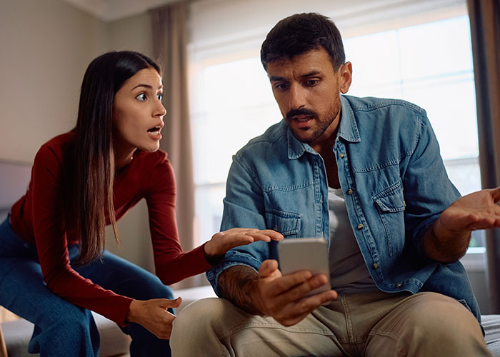 Woman and man arguing over phone evidence in a tense moment, highlighting woman&rsquo;s award winning act exposed in court.