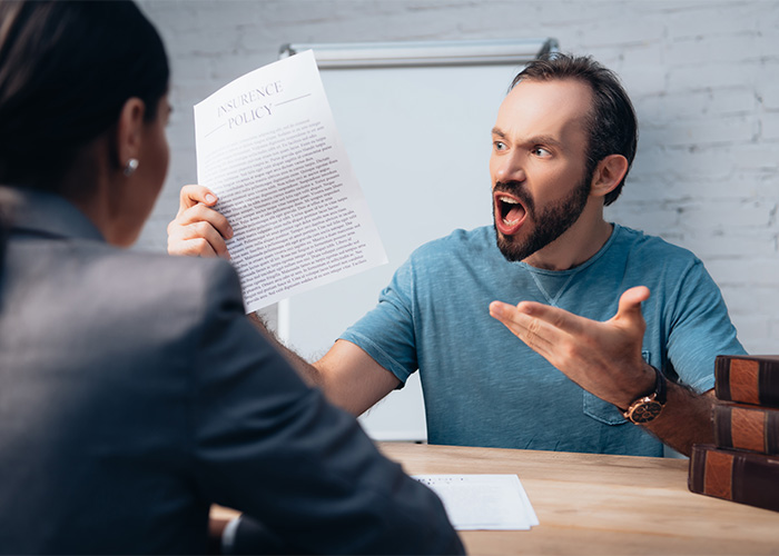 Man angrily holding a paper while arguing with a woman, illustrating a male Karen stereotype in a tense setting. Man angrily holding a paper while arguing with a woman, illustrating a male Karen stereotype in a tense setting.