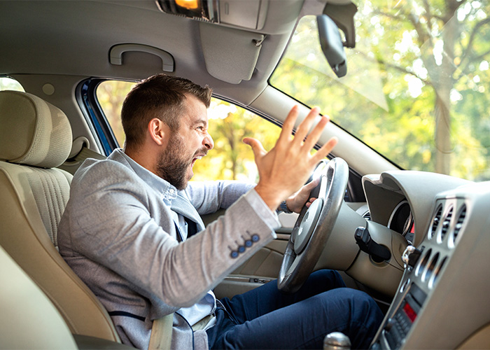 Angry man shouting inside car, expressing frustration, illustrating the concept of a male Karen by Gen Z. Angry man shouting inside car, expressing frustration, illustrating the concept of a male Karen by Gen Z.