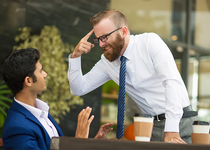 Two men in a heated discussion at a café, illustrating the concept of the male Karen debated by Gen Z. Two men in a heated discussion at a café, illustrating the concept of the male Karen debated by Gen Z.