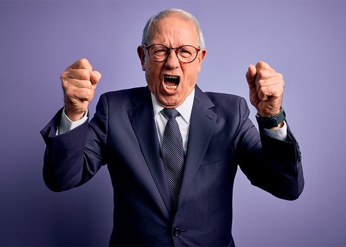 Angry older man in suit expressing frustration, representing the male Karen stereotype known by Gen Z. Angry older man in suit expressing frustration, representing the male Karen stereotype known by Gen Z.