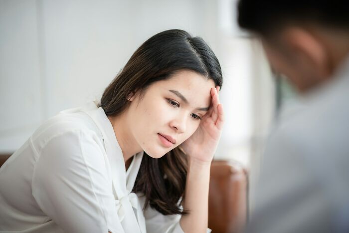 Young woman looking concerned and stressed during a discussion about daily dangers you might not realize exposing yourself to