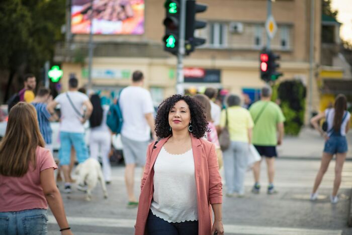 Woman walking confidently in a busy urban area, representing things women do to feel safer while living alone.