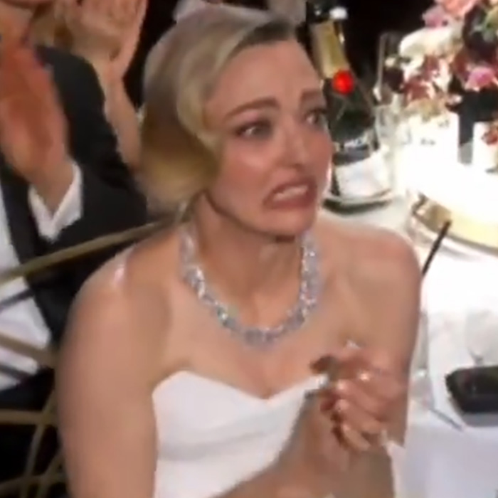 Woman in formal dress at 2026 Golden Globes looking distressed amid chaos involving stars leaving early and smoking at tables.