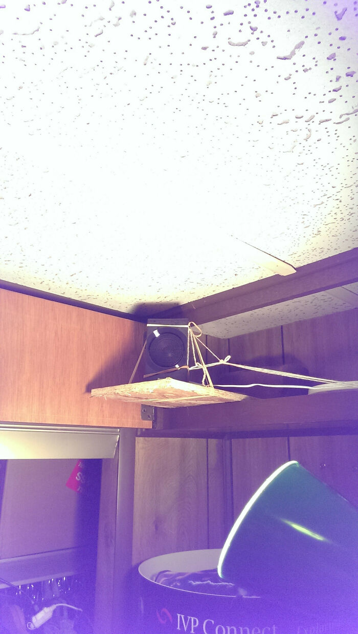 Improvised floating shelf made with string and a wooden board, a classic example of failed DIY projects needing shaming.