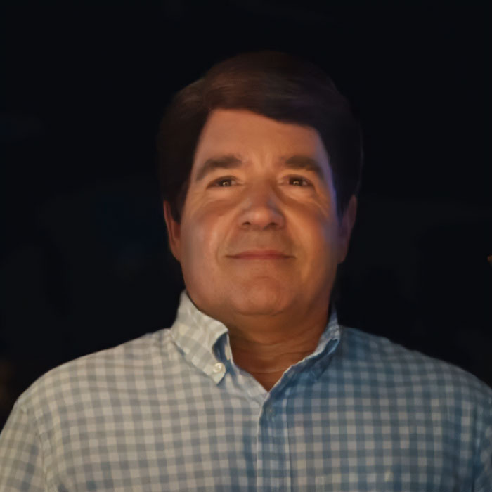 Man with dark hair wearing a checkered shirt, representing Guy Fieri's birthday glow-up and new hairstyle change.