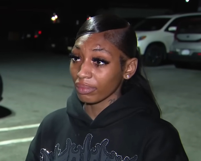 Maryland hairstylist with sleek hair and hoodie addresses the camera outside a parking lot at night after viral video incident.