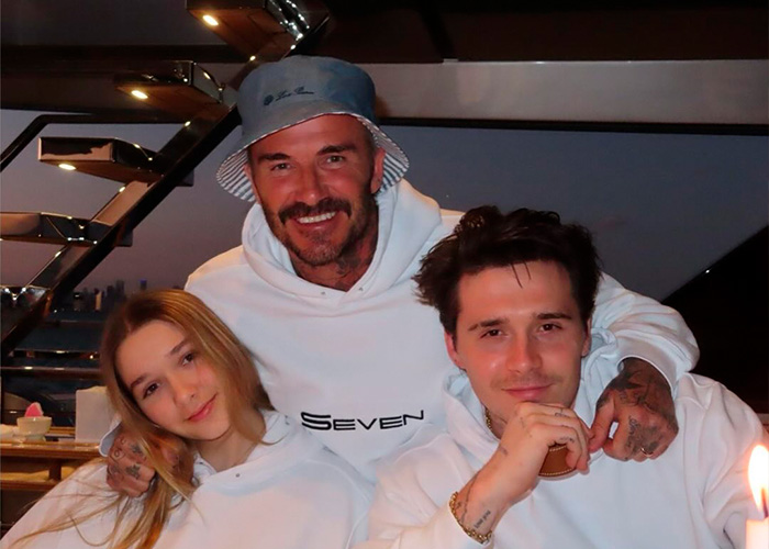 Harper Beckham with parents David and Brooklyn Beckham smiling together, breaking silence after explosive family attack news.