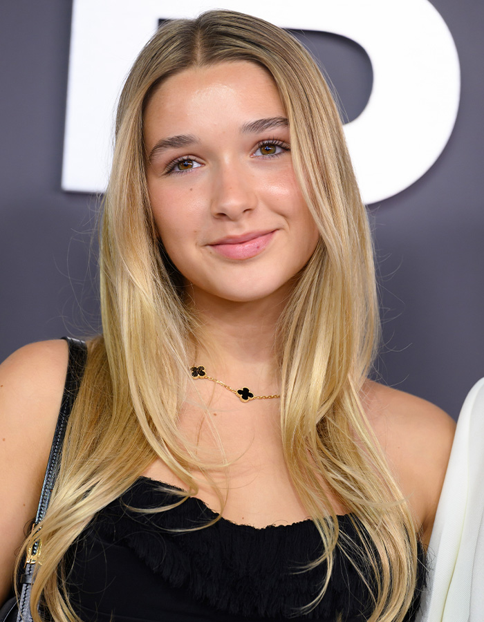 Harper Beckham smiling at an event, wearing a black top and gold necklace, relating to Brooklyn&rsquo;s attack on parents news.