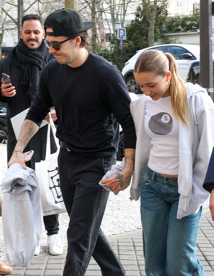Harper Beckham holding hands with a man outdoors, showing support amid Brooklyn&rsquo;s explosive attack on parents news.
