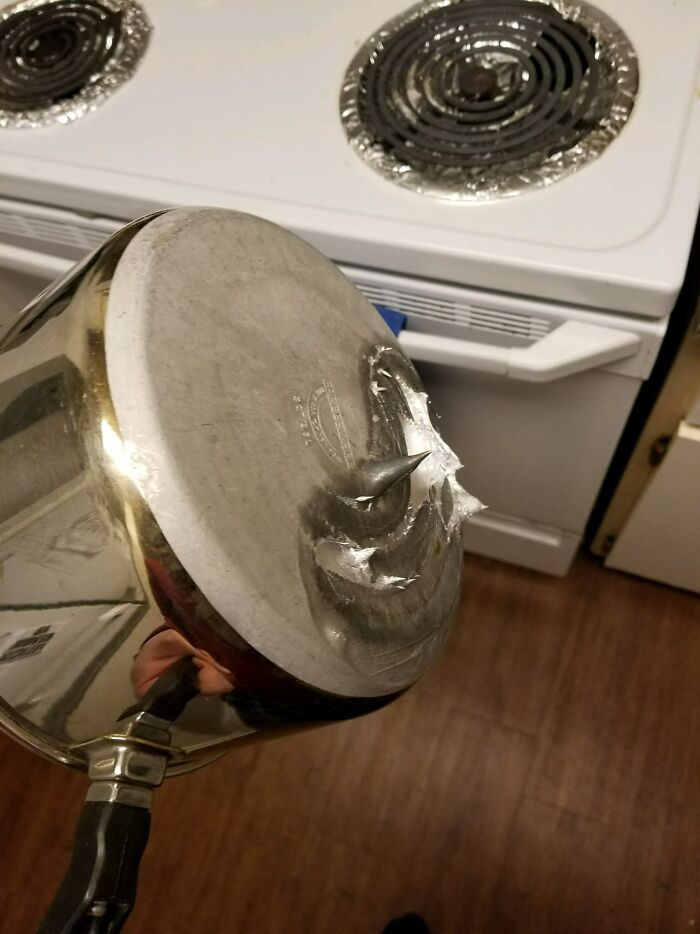 Pot bottom damaged with a sharp spike, illustrating jerks that made roommates consider living alone.