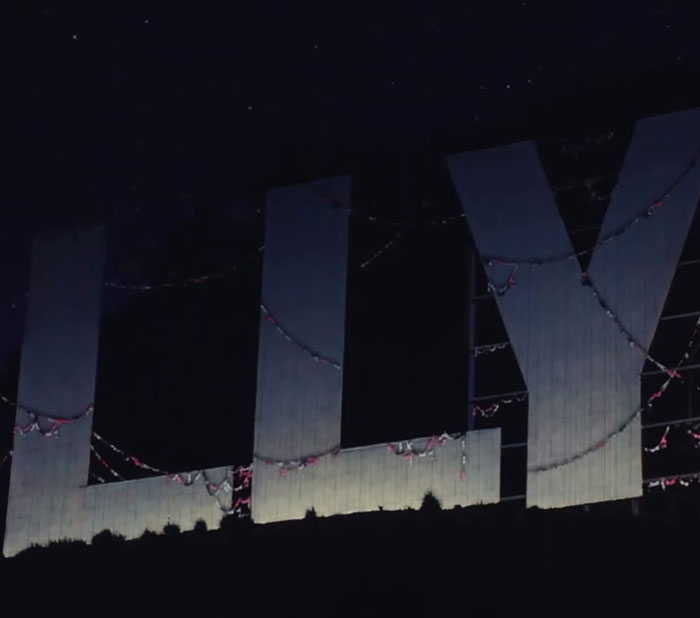 Partial view of the Hollywood sign at night with decorative lights, representing Sydney Sweeney lingerie line launch.