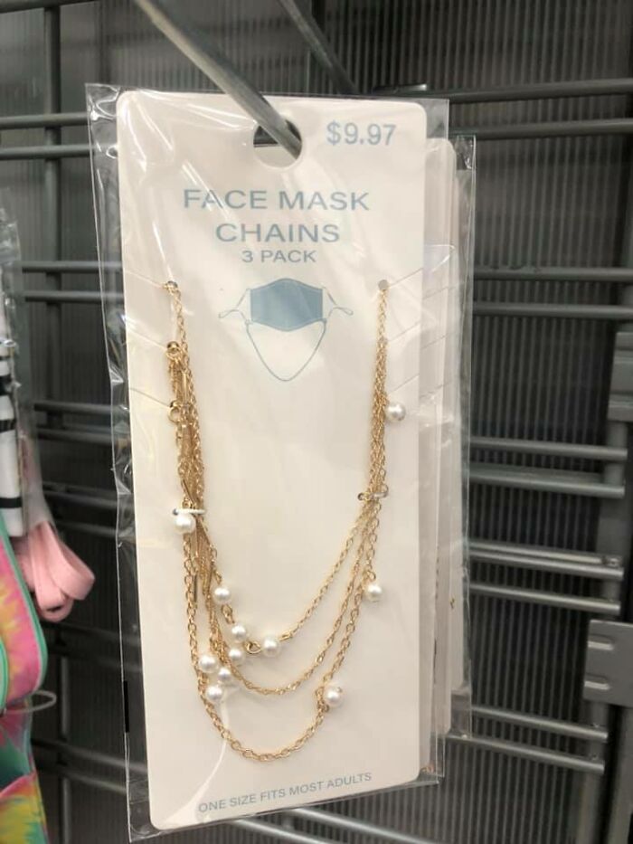 Face mask chains in gold with pearls, packaged for sale, highlighting dystopia themed everyday products.
