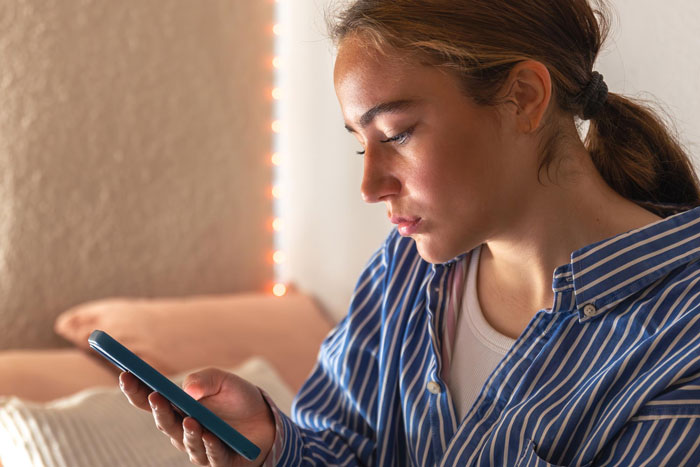 Young pregnant woman looking worried while holding a phone, concerned about co-parenting with bipolar guy and young lover. Young pregnant woman looking worried while holding a phone, concerned about co-parenting with bipolar guy and young lover.