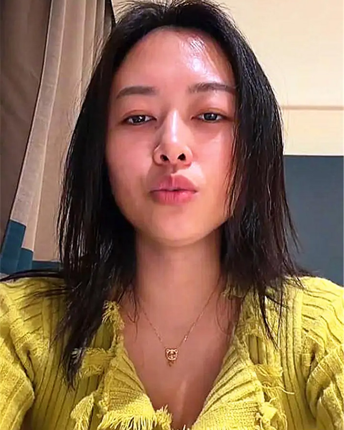 Woman with wet black hair wearing a yellow sweater and a necklace, related to divorce him and dishwasher conflict story.