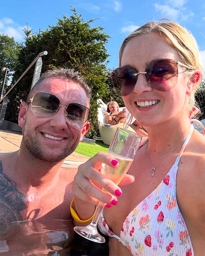 Husband heartbroken after wife&rsquo;s tragic loss, couple smiling in pool celebrating first anniversary with champagne.