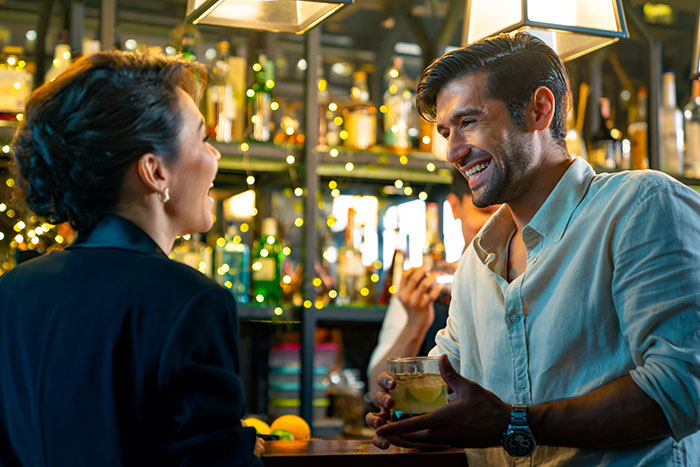 Woman venting about husband leaving her, showing trust and lack of jealousy, in a lively bar setting.