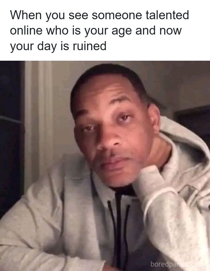 Man in gray hoodie resting his head on hand looking disappointed, a dark humor meme for those who enjoy dark humor memes.