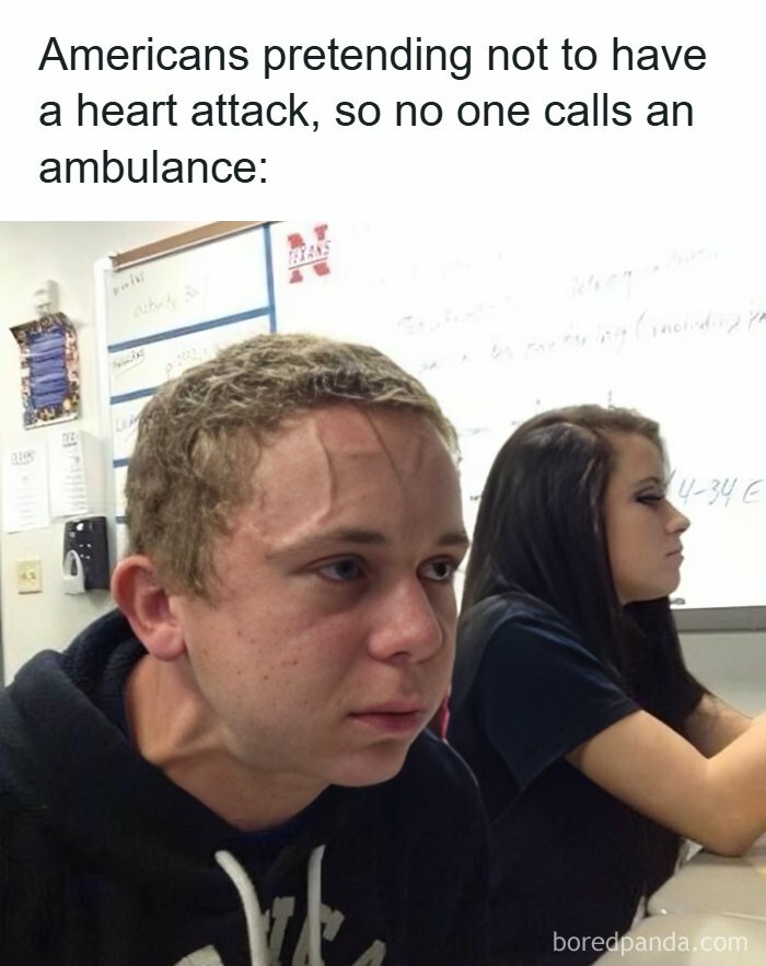 Young man in class straining with visible neck veins, illustrating healthcare memes about ignoring serious symptoms.