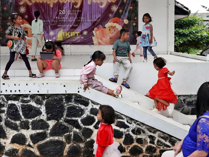 Children playing on stairs and platform in a street shot captured perfectly with vivid colors and candid moments.