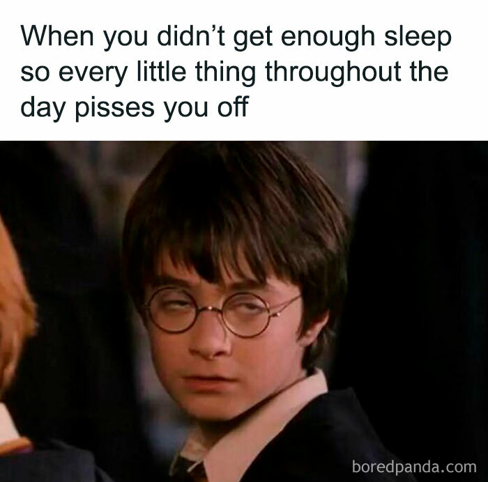 Tired young man with glasses looking annoyed, illustrating relatable memes about life as an introvert and irritability from lack of sleep.