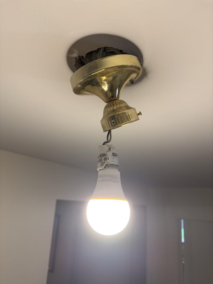 Exposed hanging light bulb with broken fixture, illustrating weird teacher behavior witnessed in class stories.