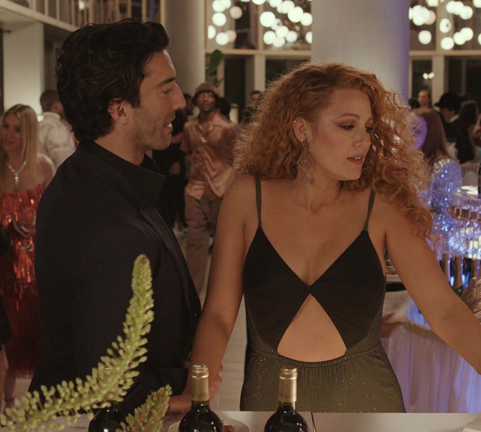 A man and woman at a party bar engaging in conversation with guests in the background, lively atmosphere. A man and woman at a party bar engaging in conversation with guests in the background, lively atmosphere.