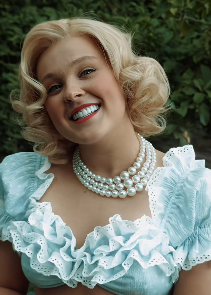 JoJo Siwa smiling in vintage style outfit and pearl necklace, showcasing dramatic transformation and name change update.