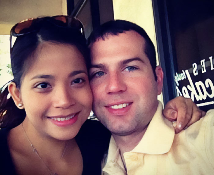 Couple smiling closely together in a casual setting, related to father of ICE agent amid immigrant wife news.