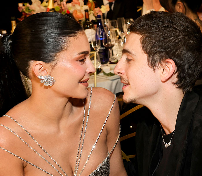Kylie Jenner and Timoth&eacute;e Chalamet sharing a close moment at an event, hinting at a lip reader revealing a fight.