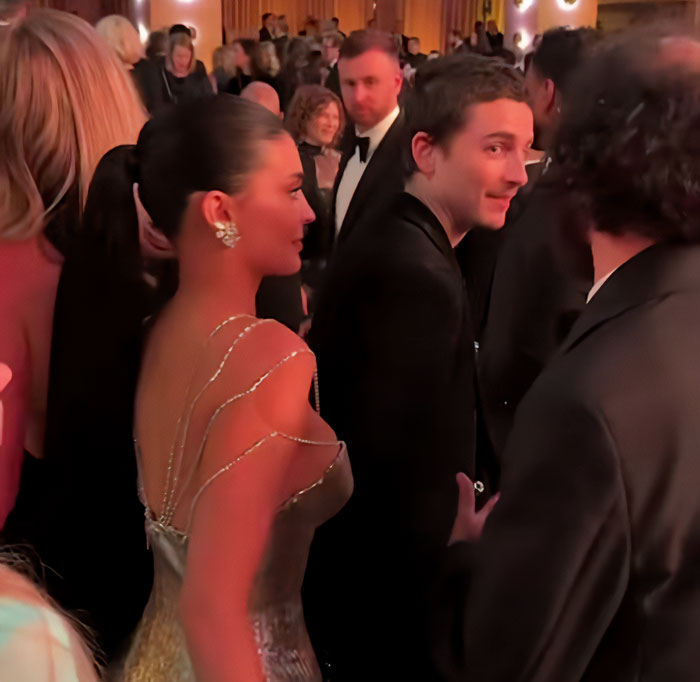 Timoth&eacute;e Chalamet and Kylie Jenner captured in a crowded Golden Globes event moment.