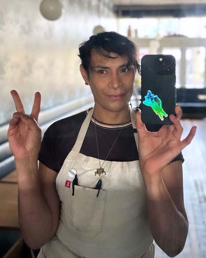Trans chef taking a selfie in apron making peace sign, related to media coverage controversy and J.K. Rowling comments. Trans chef taking a selfie in apron making peace sign, related to media coverage controversy and J.K. Rowling comments.