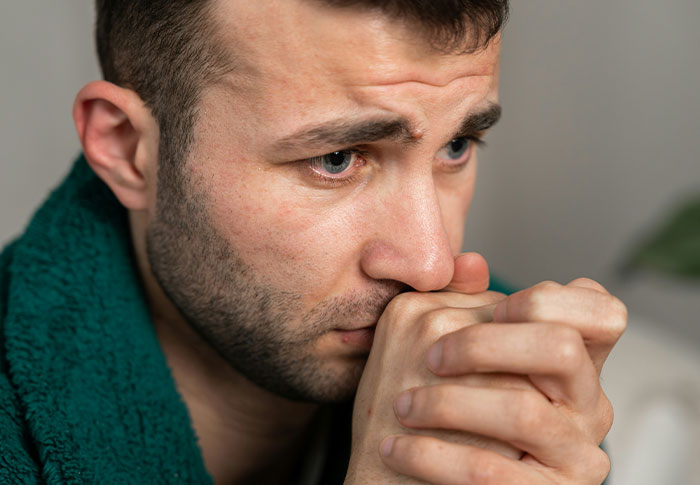 Man in apartment looking worried and anxious, noticing strange things and uncovering a creepy unsettling truth.