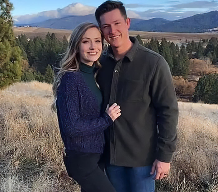 Couple posing outdoors with scenic mountain and forest background during a casual fall day. Couple posing outdoors with scenic mountain and forest background during a casual fall day.