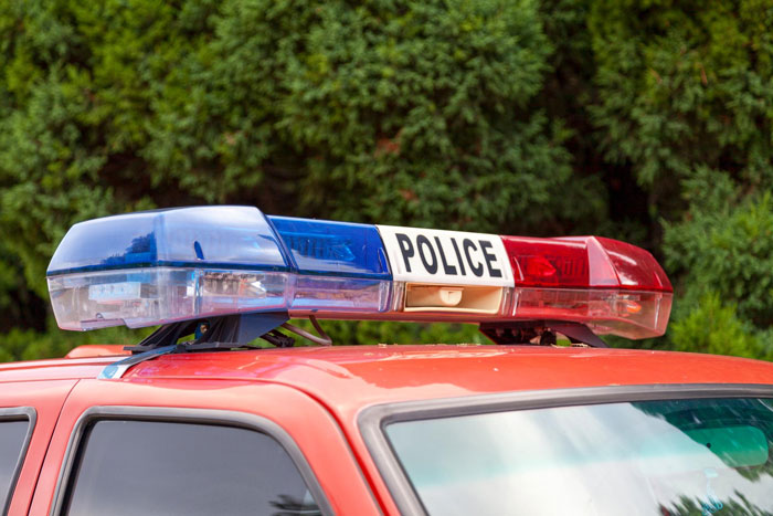 Police car light bar on red vehicle representing family drama with police officer arresting his own mother-in-law. Police car light bar on red vehicle representing family drama with police officer arresting his own mother-in-law.