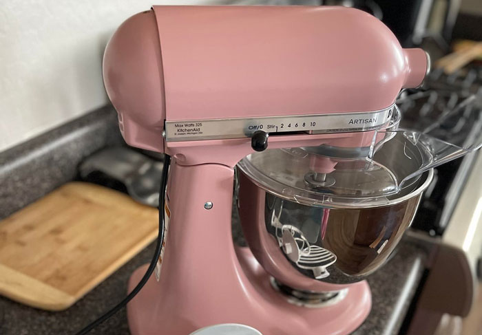Pink KitchenAid Artisan stand mixer on kitchen counter, highlighting family moments and gift ideas for mom&rsquo;s birthday.