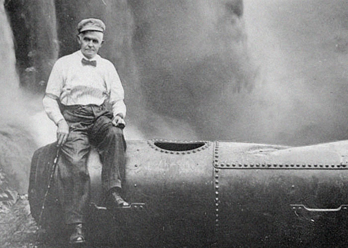 Man in vintage clothing sitting on an early submarine, illustrating ironic ways people passed away in history.