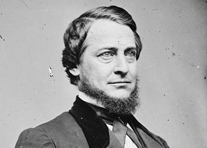 Black and white portrait of a man with beard and formal attire, representing ironic ways people passed away.