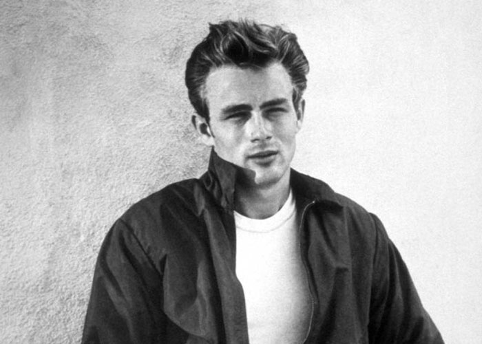 Black and white photo of a young man with styled hair wearing a jacket and white shirt, symbolizing ironic ways people passed away.