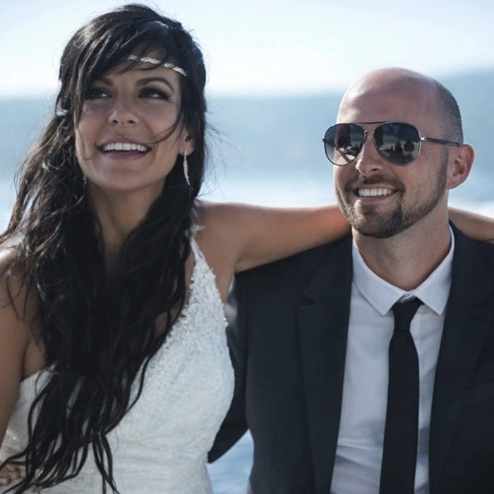 Couple smiling outdoors against a blue sky backdrop, unrelated to Swiss resort blaze or disturbing details. Couple smiling outdoors against a blue sky backdrop, unrelated to Swiss resort blaze or disturbing details.