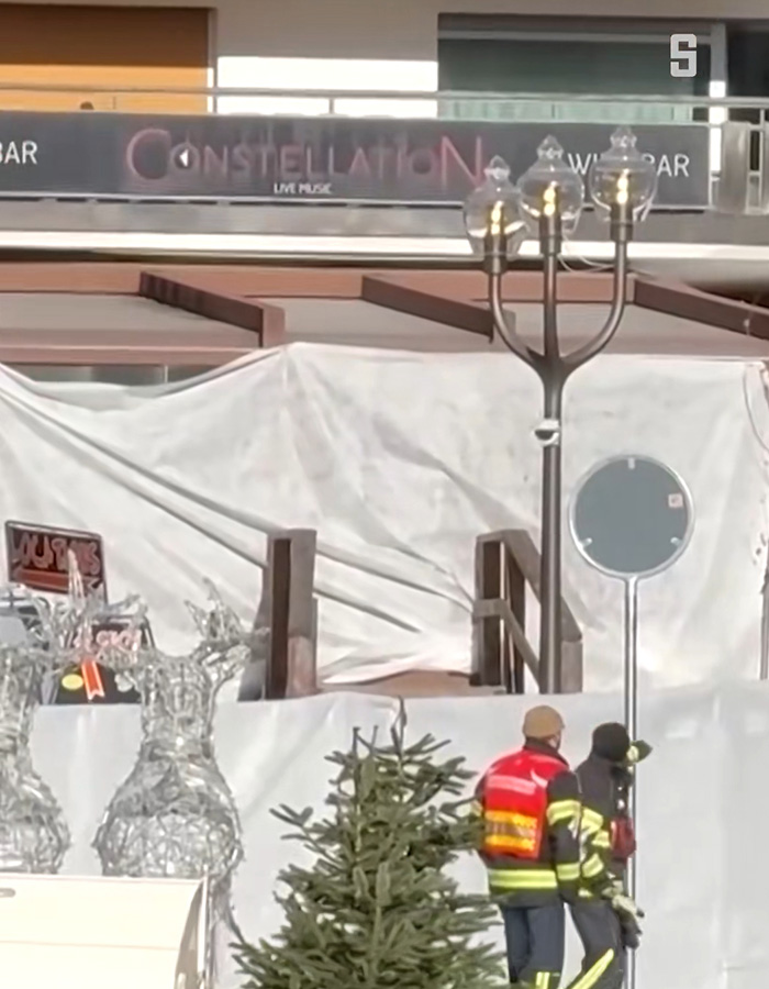 Firefighters inspect the Swiss ski bar site covered after lethal fire, highlighting possible negligence cause in the accident.