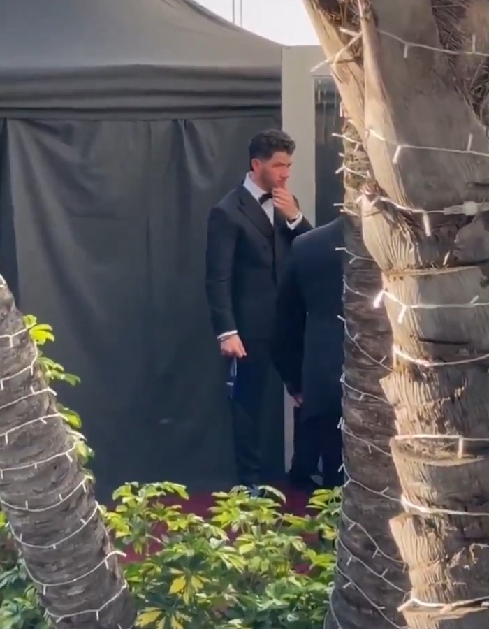 Nick Jonas in a black tuxedo walking out at Golden Globes 2026, captured in a viral video revealing the moment.