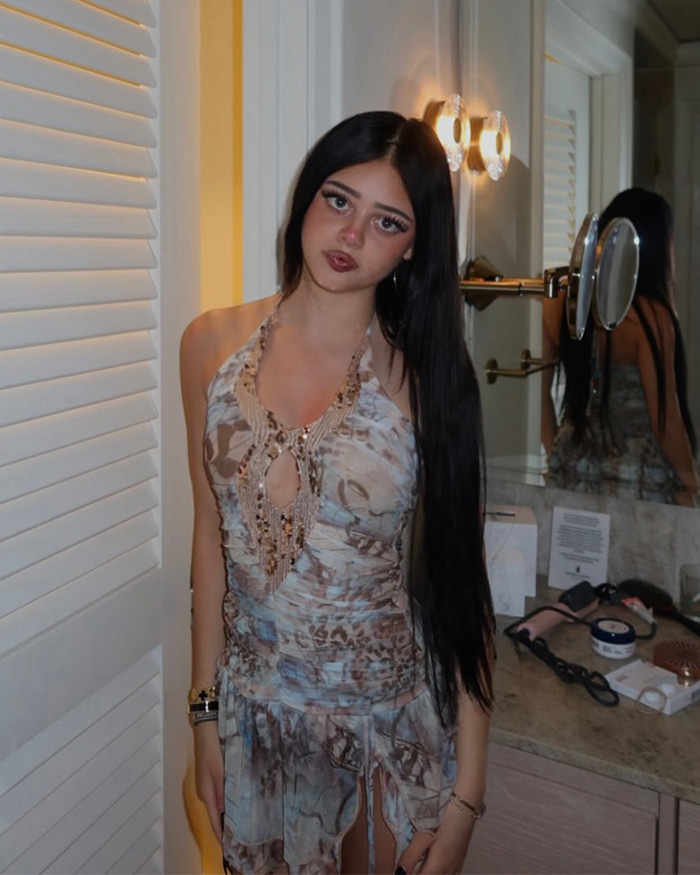 Nicole Richie's 18-year-old daughter posing indoors in a patterned dress with long black hair.