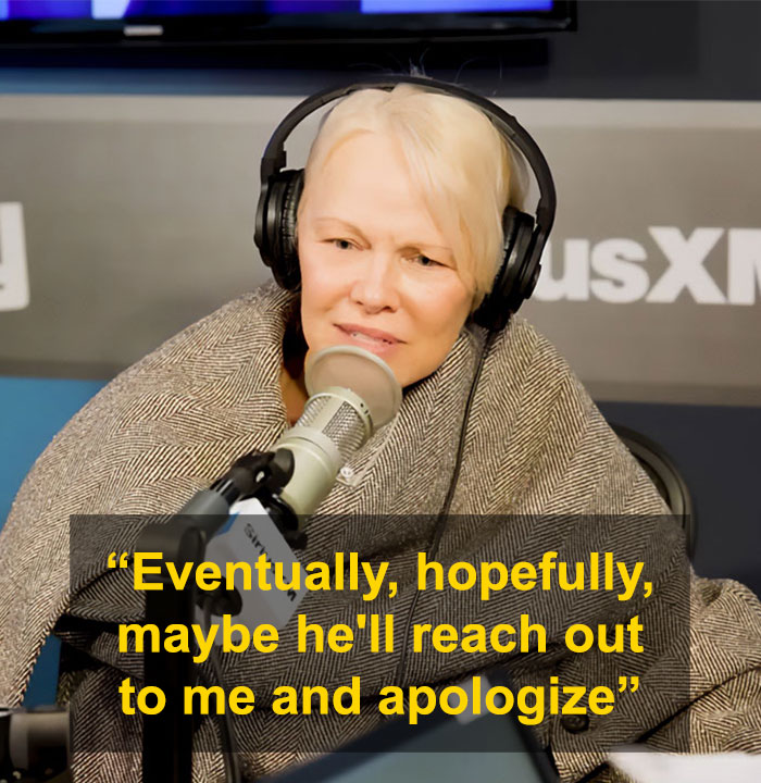 Pamela Anderson speaking in a radio studio wearing headphones, discussing apology from Seth Rogen after Golden Globes incident.