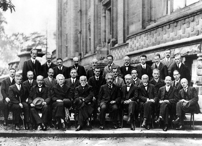Historic black and white group photo of prominent men and one woman from an important event in their country’s history.