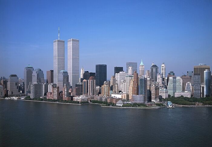 Moments People Faced - Manhattan skyline with Twin Towers and Hudson River under clear blue sky