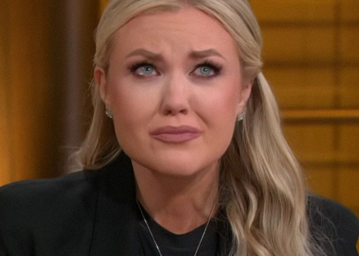 Woman with long blonde hair and teary eyes expressing emotion in a close-up about celebrity passings and disbelief.