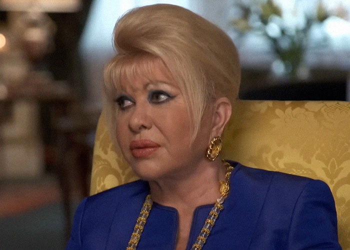 Woman with blonde hair and gold jewelry seated on yellow chair, relating to celebrity passings that seem random.