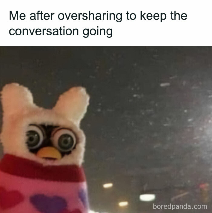 Relatable meme of a wide-eyed Furby wrapped in a blanket, illustrating oversharing to keep conversations going.
