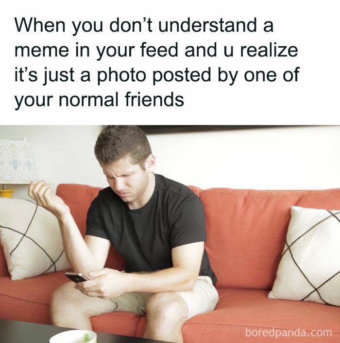 Man on couch confused by meme in feed, illustrating relatable memes that make you feel called out online.